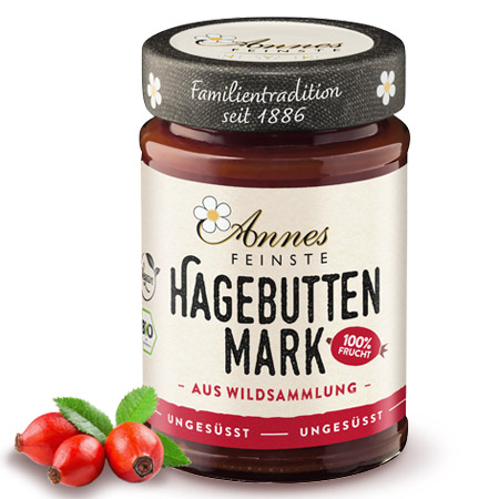 Annes Feinste Bio Hagebuttenmark Glas Annes Feinste Bio Hagebuttenmark, daneben Hagebutten.