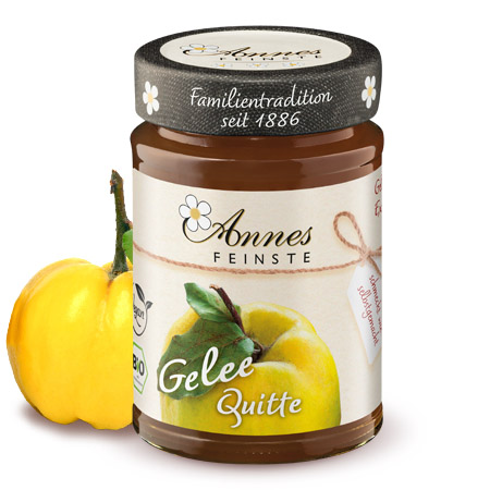 Annes Feinste Bio Quitten-Gelee extra Glas Annes Feinste Bio Quitten-Gelee extra, daneben eine Quitte.
