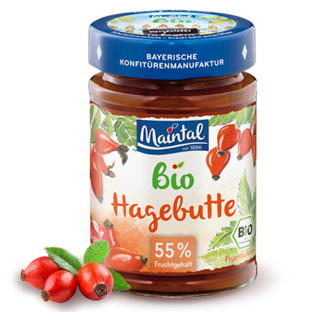 Bio + vegan Hagebutten-Fruchtaufstrich Glas Maintal Bio Hagebutten-Fruchtaufstrich, daneben Hagebutten.
