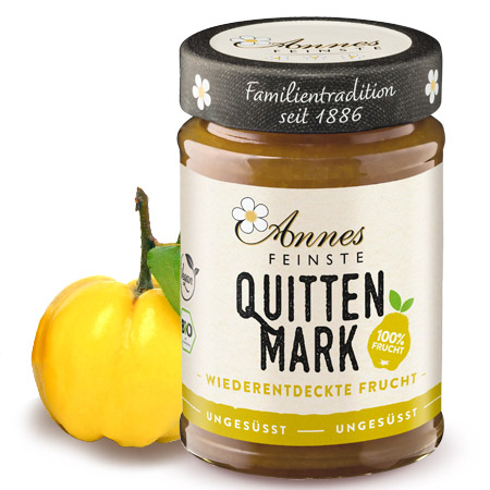 Annes Feinste Bio Quittenmark Glas Annes Feinste Bio Quittenmark, daneben eine Quitte.