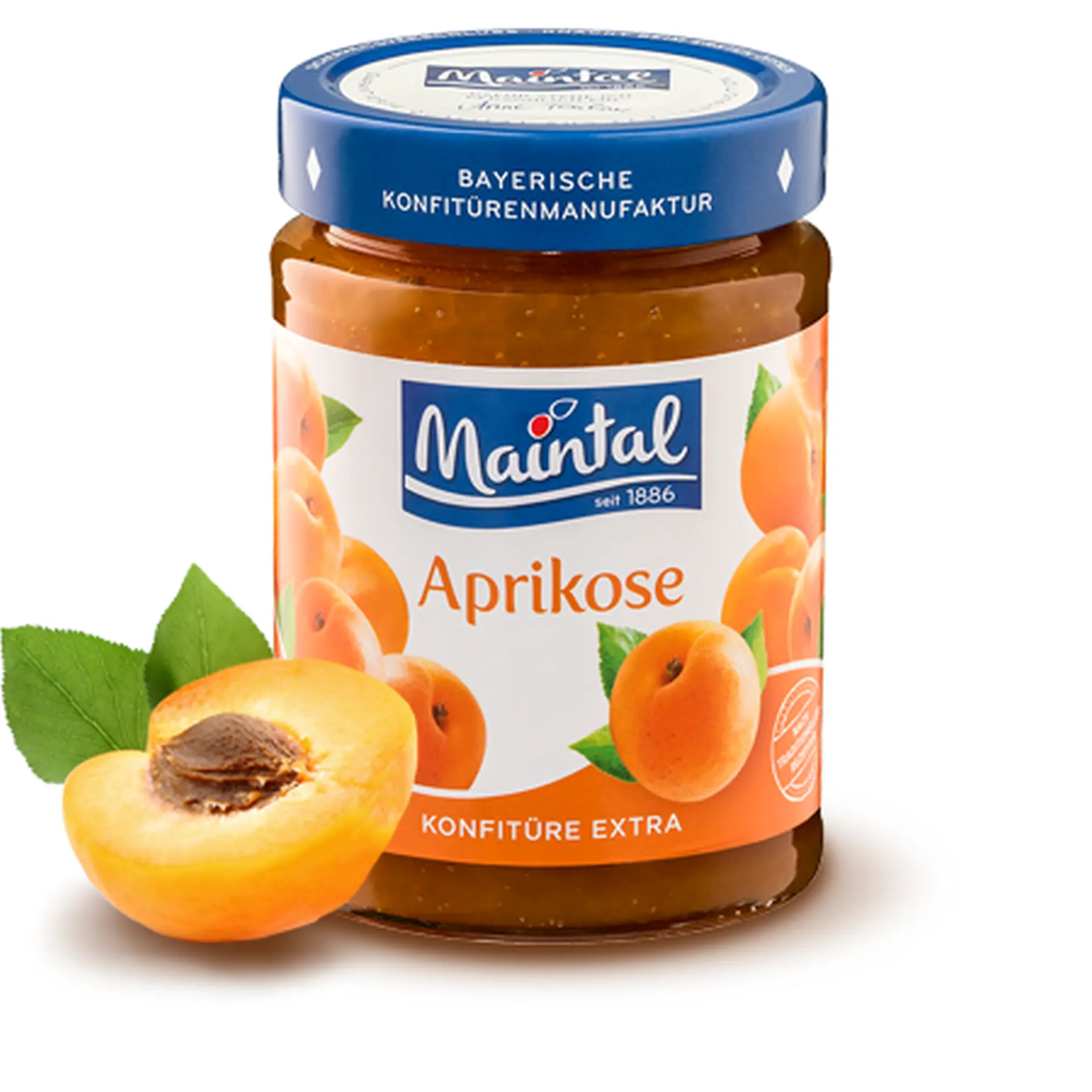 Glas Aprikosen-Konfitüre extra, daneben halbe Aprikose.