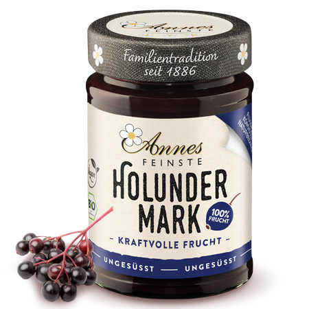 Annes Feinste Bio Holunderbeerenmark Glas Annes Feinste Bio Holunderbeerenmark, daneben Holunderbeeren.